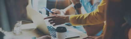 The DevOps Contact image shows a close up of people working around a table. On the table, you see papers, a laptop, coffee cups, water cups, etc.