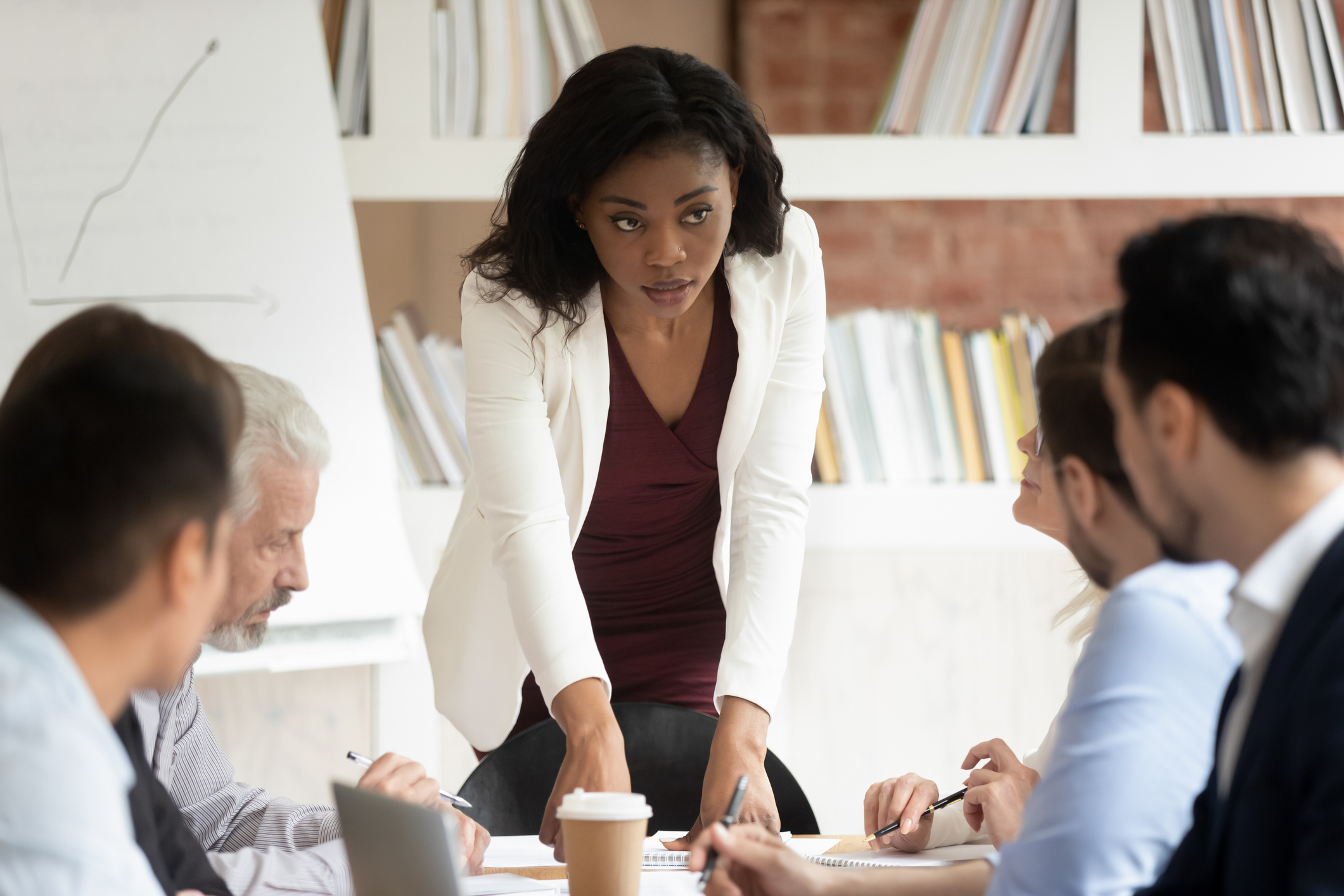 Businesswoman talking with employees about developing MVP for enterprise organization