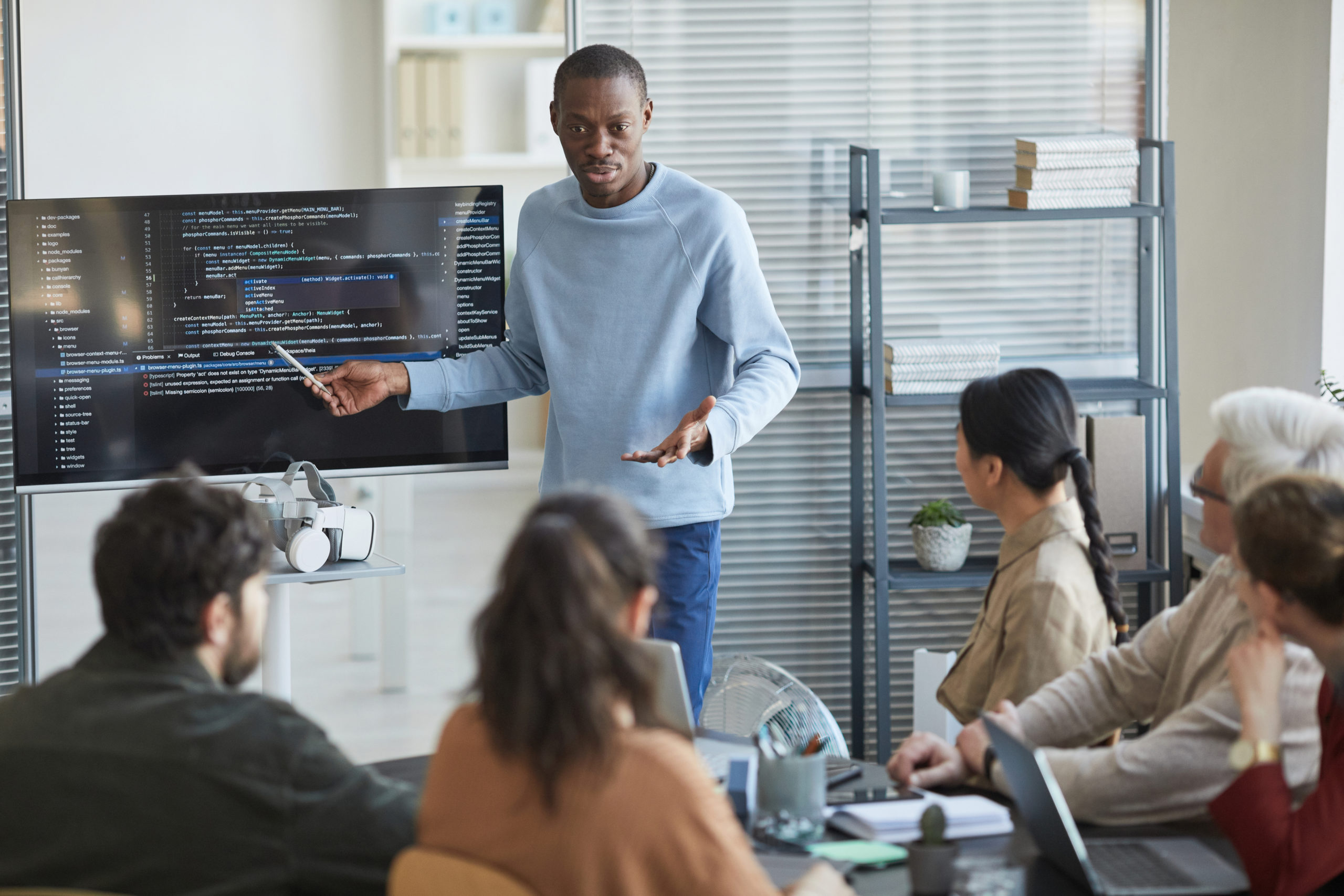 Man giving IT presentation to a group of software developers 