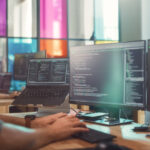 Professional Male Data Scientist Writing Code on Desktop Computer in Stylish Office Space. Caucasian Man Using Software to Analyze Information From Internet and Improve Performance.