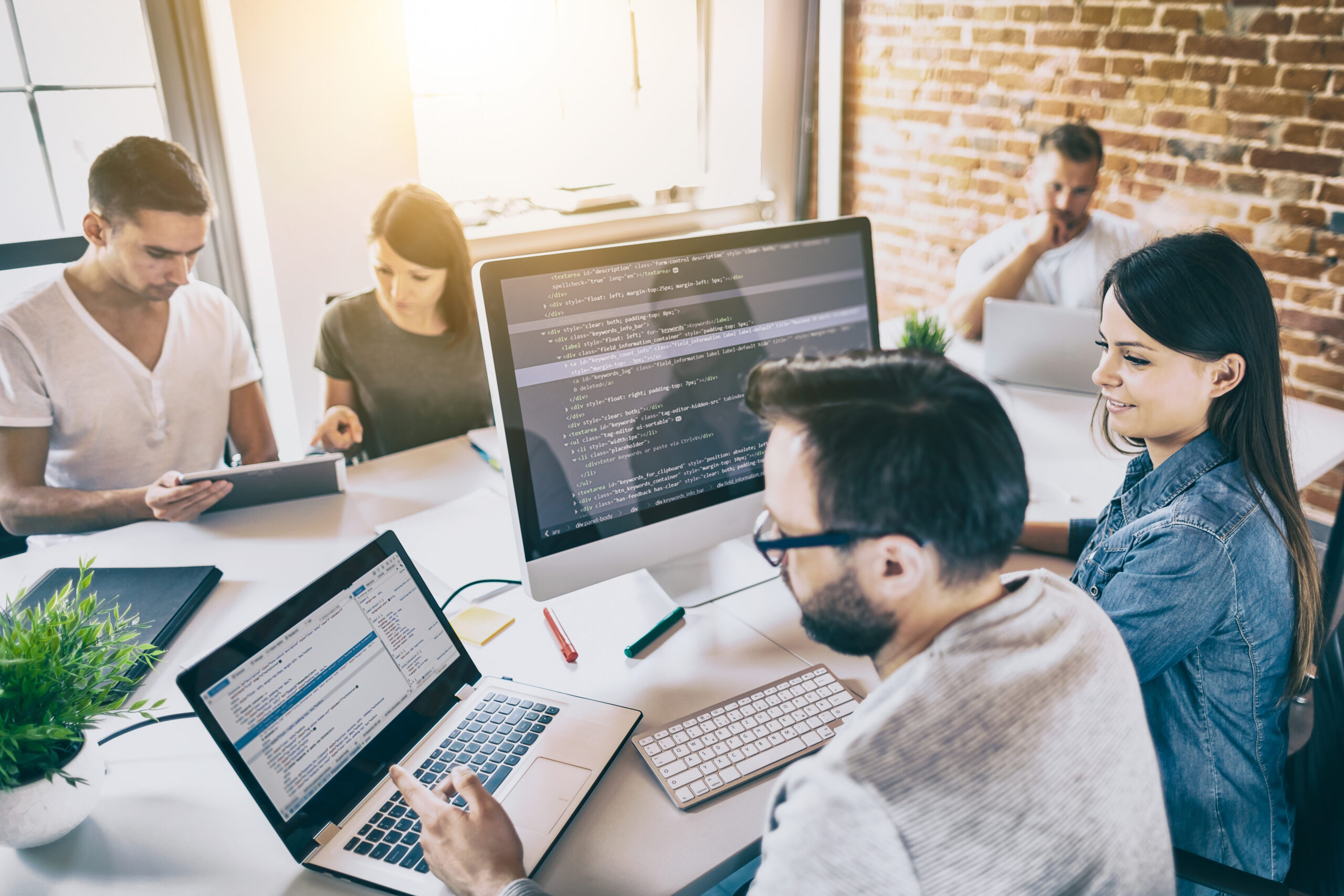 Programming team working in a software development company office.